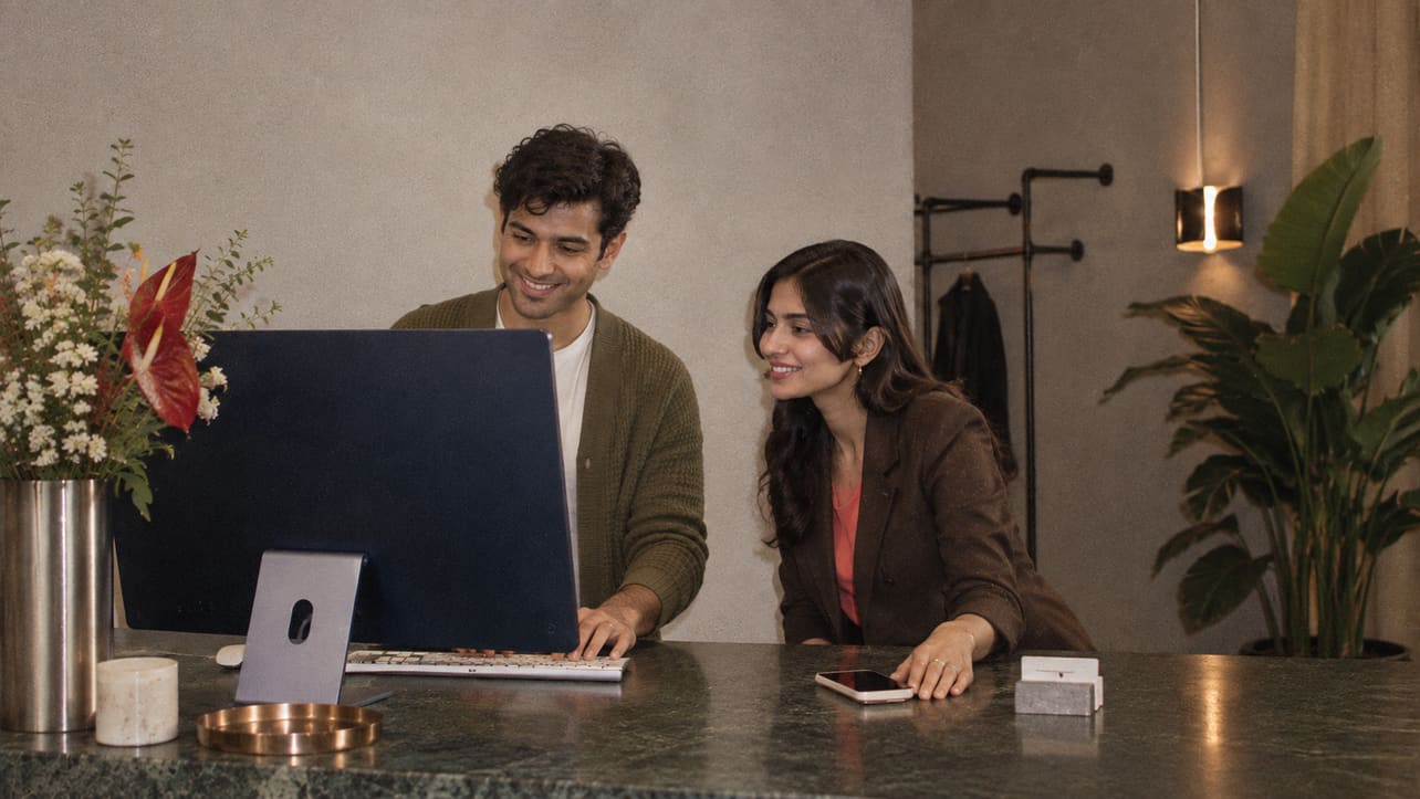 Two colleagues reviewing their week together at the counter
